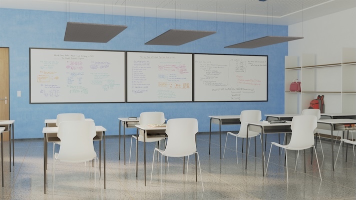 Modern classroom with white chairs and desks, three large whiteboards mounted on a blue wall, and hanging acoustic ceiling panels overhead.