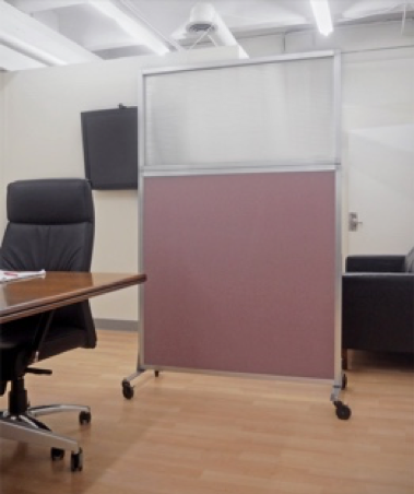 A Hush Screen™ Portable Partition sits behind a desk at an office.