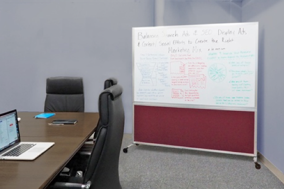 A DivideWrite whiteboard is on display in a conference room.