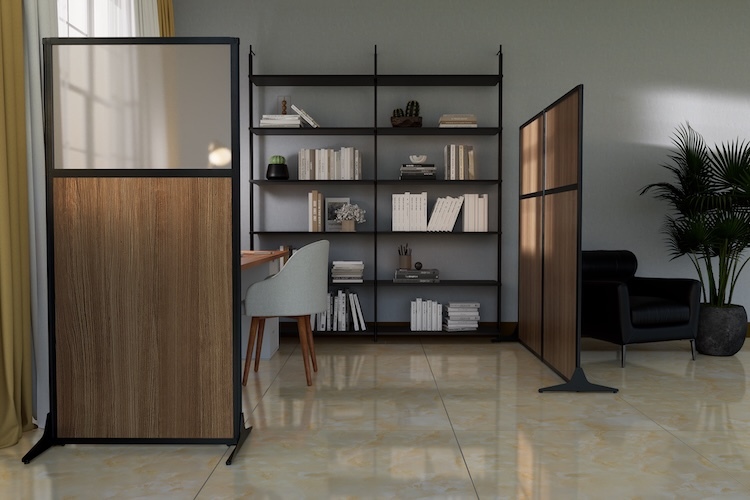 Modern office interior featuring freestanding room dividers with wood panels and translucent upper sections, a black shelving unit with books and plants, a desk and chair, and a black lounge chair with a potted palm.