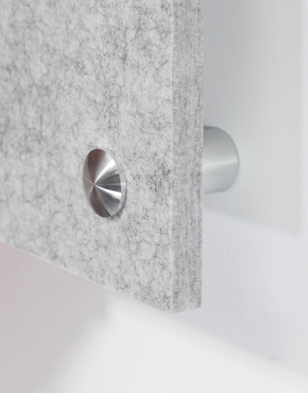 Close-up of a gray acoustic felt wall panel mounted with brushed stainless steel standoff hardware, highlighting the panel's textured surface, thickness, and floating installation against a white wall.