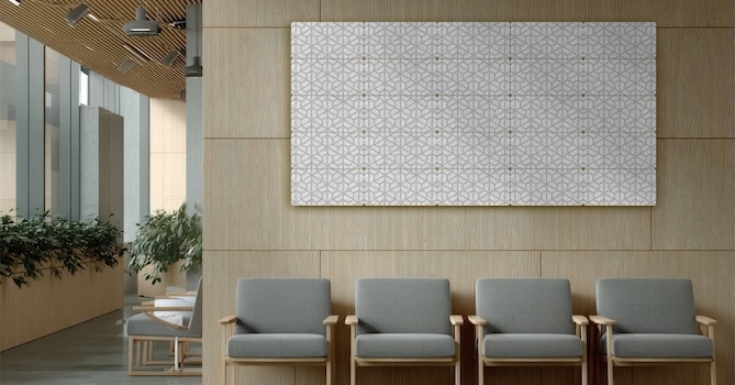 Modern waiting room with gray chairs, wood-paneled walls, and a geometric acoustic wall panel.