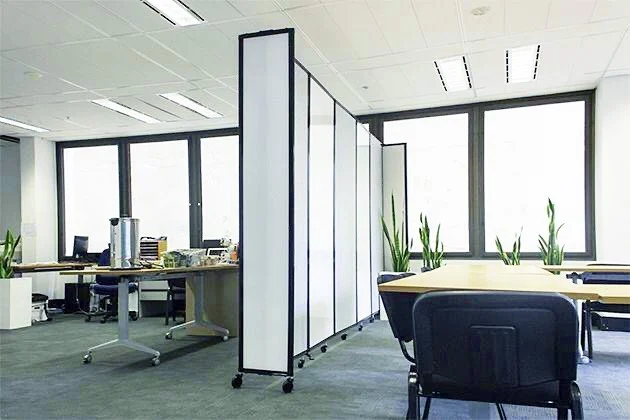 A room divider separates a large room into two separate meeting areas.